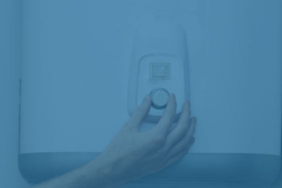 Hand adjusting house thermostat to desired temperature