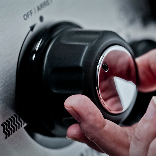 Close-up of temperature control knobs on the Broil King Crown® S 440 grill, offering precise heat adjustments for your grilling needs