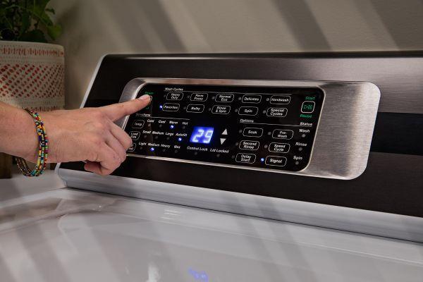 Speed Queen TR7003WN 25 5/8" Top Load Washer - Person using the control panel to operate the washer
